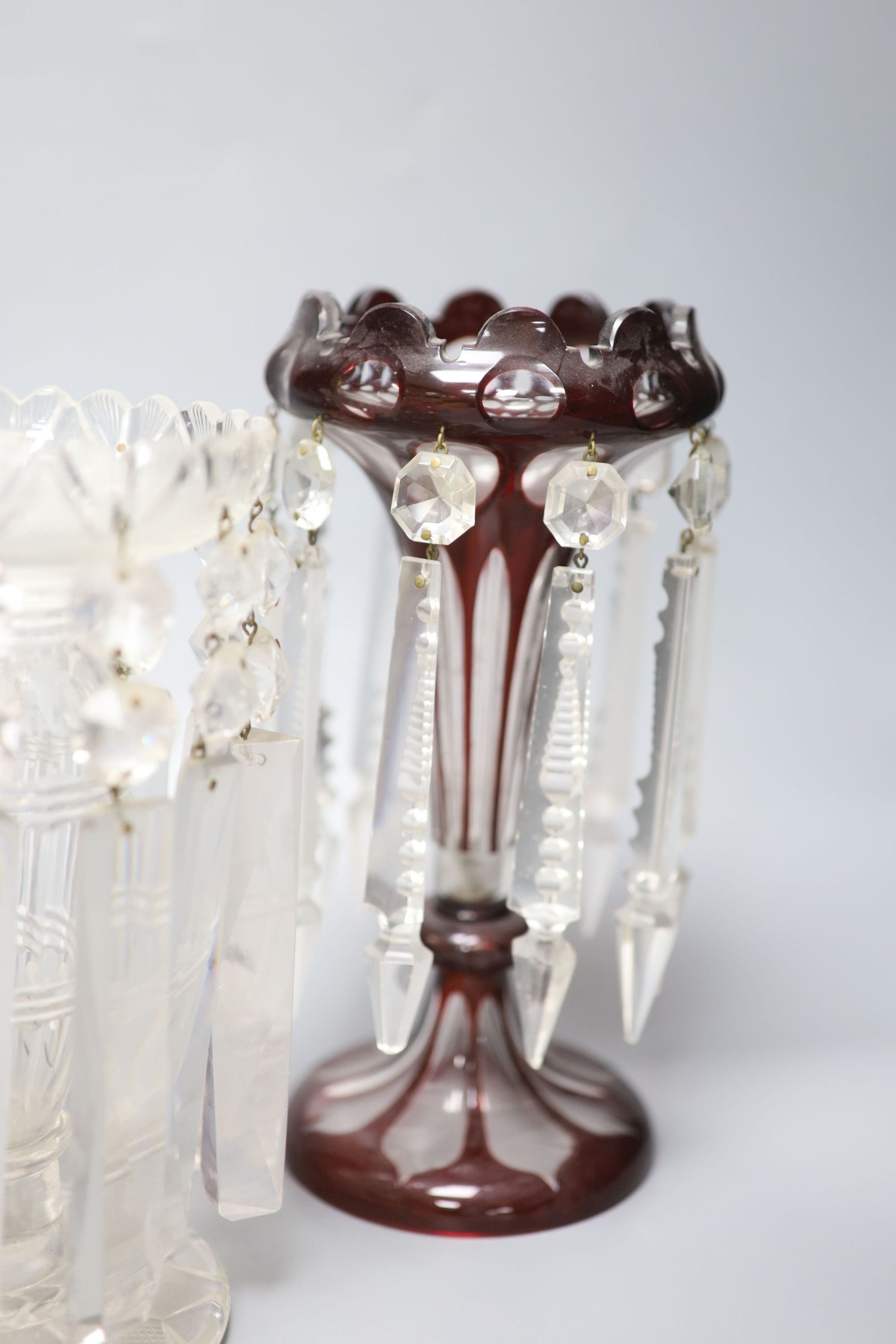 A pair of Victorian ruby overlaid table lustres and a pair of late Victorian clear glass table lustres, height 24cm